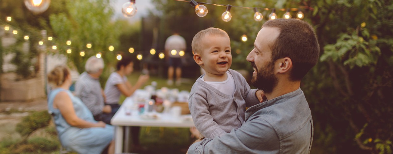 father and young son laughing together at a picnic
