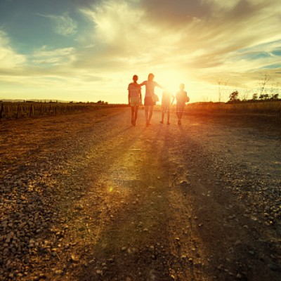 Family walking towards a sunset